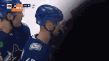 a hockey game is being played between the vancouver canucks and the philadelphia flyers