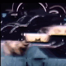 a close up of a car 's exhaust pipe with a few drops of water coming out of it