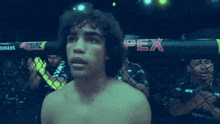 a man stands in front of a cage with the word pex on it