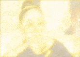 a yellow background with a blurred image of a person in the middle