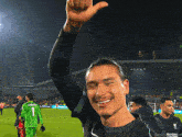 a soccer player wearing a shirt that says standard chartered on it