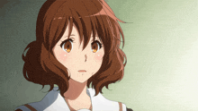 a close up of a girl with brown hair and orange eyes
