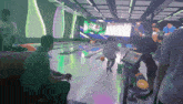 a group of people are playing bowling in a dark bowling alley