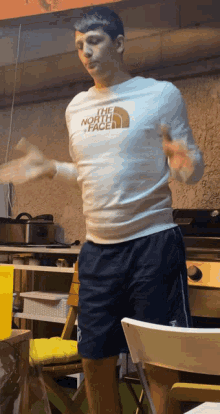 a man wearing a north face shirt is dancing