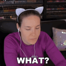 a woman wearing a headband with cat ears and headphones says what