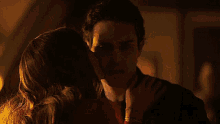 a man and a woman are standing next to each other and looking at each other .
