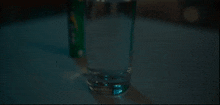 a glass of water next to a can of soda