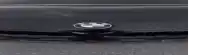 a black car with a bmw logo on the front bumper .