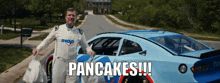 a man standing in front of a car that says ihop on it