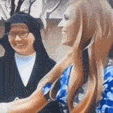 a painting of a nun and a woman with long blonde hair