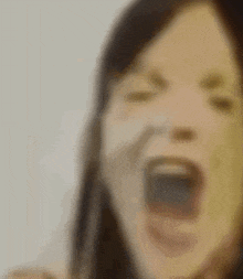 a blurry picture of a woman with her mouth open .
