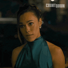 a woman in a blue dress with the word countdown on her face