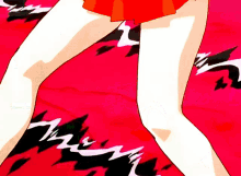 a woman in a red skirt is standing on a red surface with black and white lines on it
