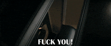 a dark room with the words " fuck you " written on it