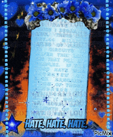 a sign that says hate hate hate is surrounded by blue flowers