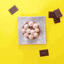 a person is holding a ferrero rocher on top of a cake