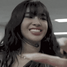 a woman wearing a headset is smiling and waving