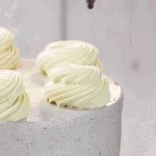 a cake is being decorated with chocolate frosting