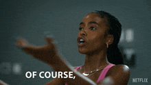 a woman in a pink tank top says " of course of course " on the screen