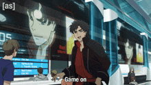 a man is standing in front of a screen that says game on