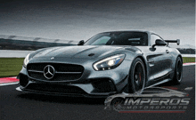 a picture of a mercedes on a race track with imperios motorsports in the background