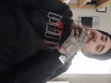 a man wearing a black hoodie that says ' bull ' on it