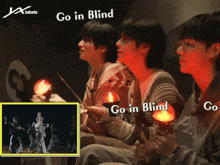 a group of people holding candles with the words go in blind on the bottom