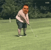 a man swings a golf club on a golf course with the time 0:05