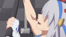 a girl with white hair and a blue headband is holding a barbell .