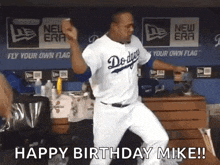 a dodgers baseball player is dancing in the dugout .
