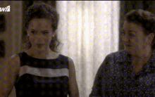 two women are standing next to each other in front of a screen that says w1 on it