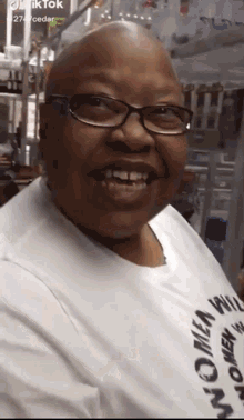 a woman wearing glasses and a t-shirt that says women