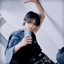 a person taking a picture of themselves with a phone