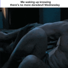 a shirtless man in a dark room with a caption that says me waking up knowing there 's no more daredevil