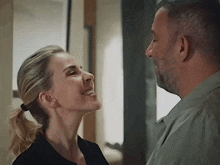 a man and a woman are looking at each other