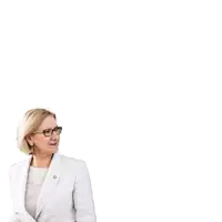 a woman wearing glasses stands in front of a sign that says " miteinander weiter gerade jetzt "