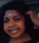 a close up of a woman 's face with her mouth open and her tongue out .