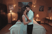 a man and a woman kissing in a bedroom