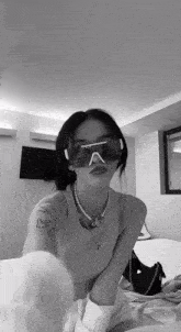 a woman wearing sunglasses and a necklace with the letter j on it