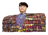 a man is covered in medals and ribbons and is wearing a black beret .