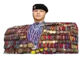 a man is covered in medals and ribbons and is wearing a black beret .