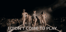 a group of women are dancing on a stage with the words " i did n't come to play " below them
