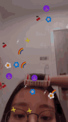 a woman wearing glasses is getting her hair done with stickers on it