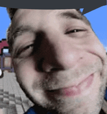 a pixelated image of a man 's face with his eyes closed and smiling