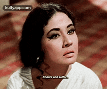 a close up of a woman 's face with the words endure and suffer
