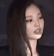 a close up of a woman 's face with her eyes closed