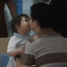 a gif of a woman kissing a child with aa + gif written on the bottom