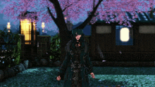 a woman in a black coat stands in front of a house with pink flowers