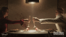 a poster for daredevil born again shows a man and woman toasting with champagne