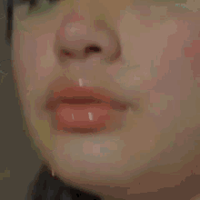 a close up of a woman 's ear and face with green eye makeup .